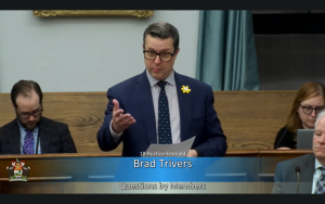 Brad Trivers speaks in the legislative assembly of PEI asking questions about building on private roads